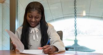 An image of a student doing paperwork. 